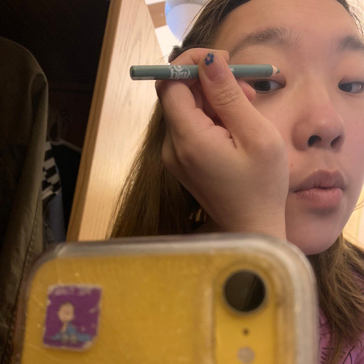 Emma Choi applying Glossier Play eyeliner