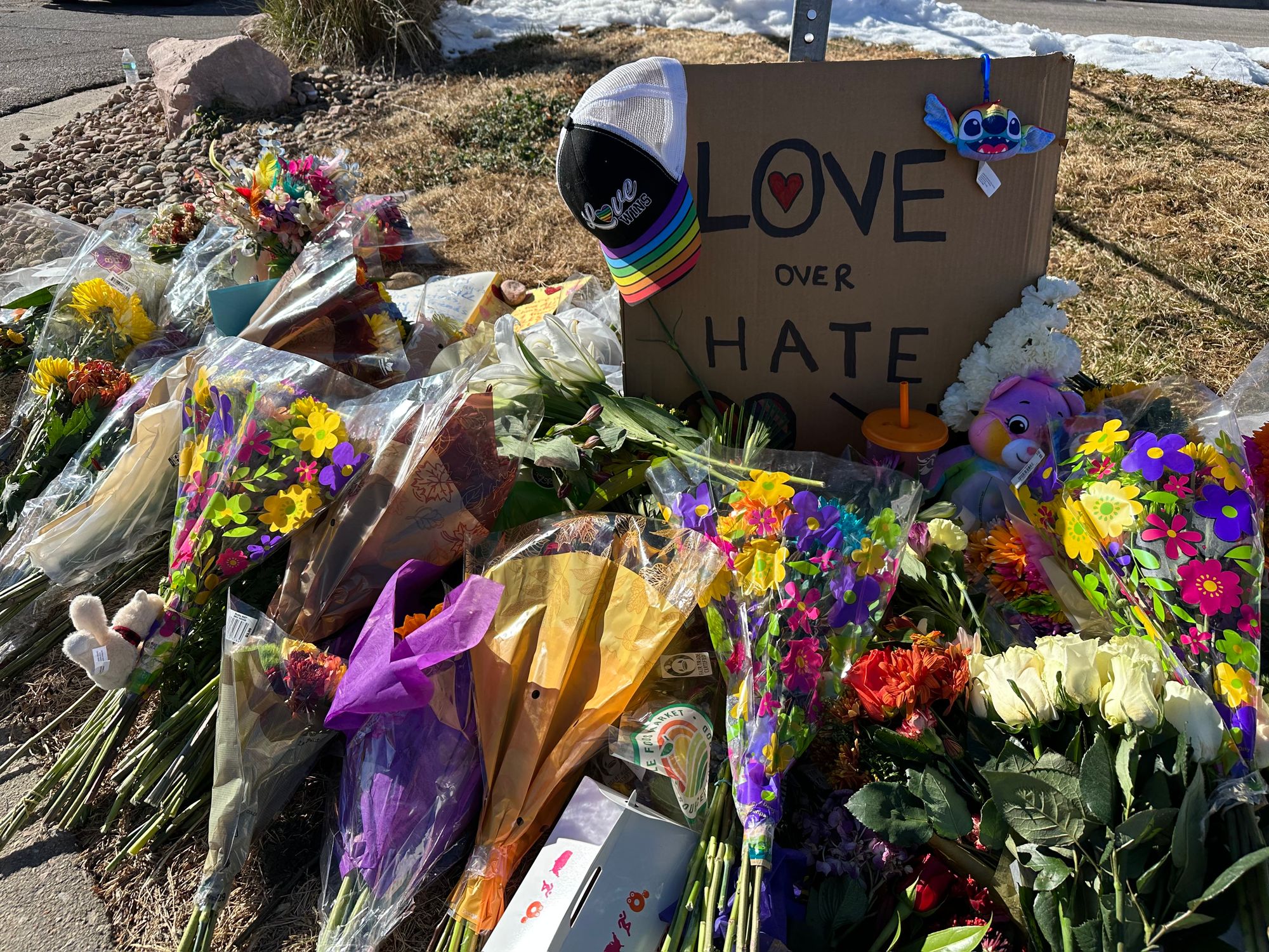 Love over Hate sign with flowers at Club Q Colorado Springs