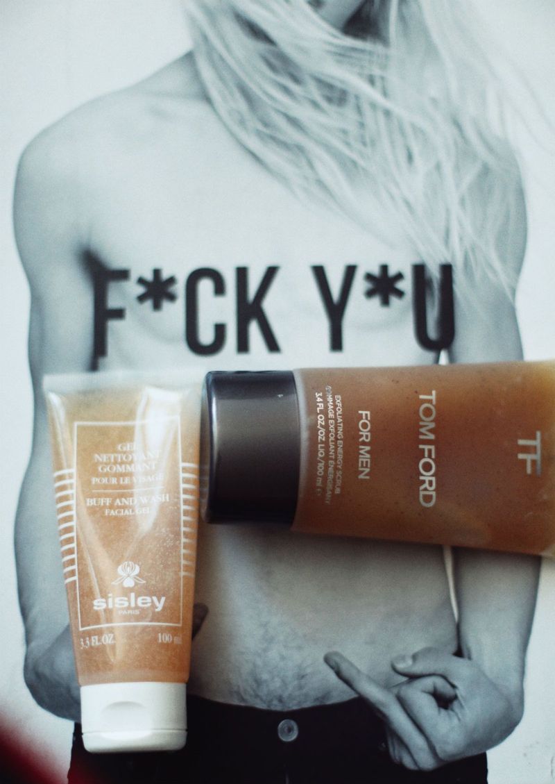 Magazine background with letters "F*CK Y*U". Sisley Buff and Wash Facial Scrub, Tom Ford Exfoliating Energy Scrub.