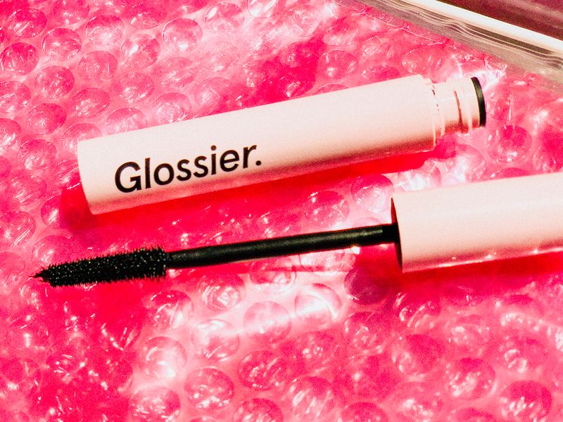 Glossier mascara with hot pink background. 
