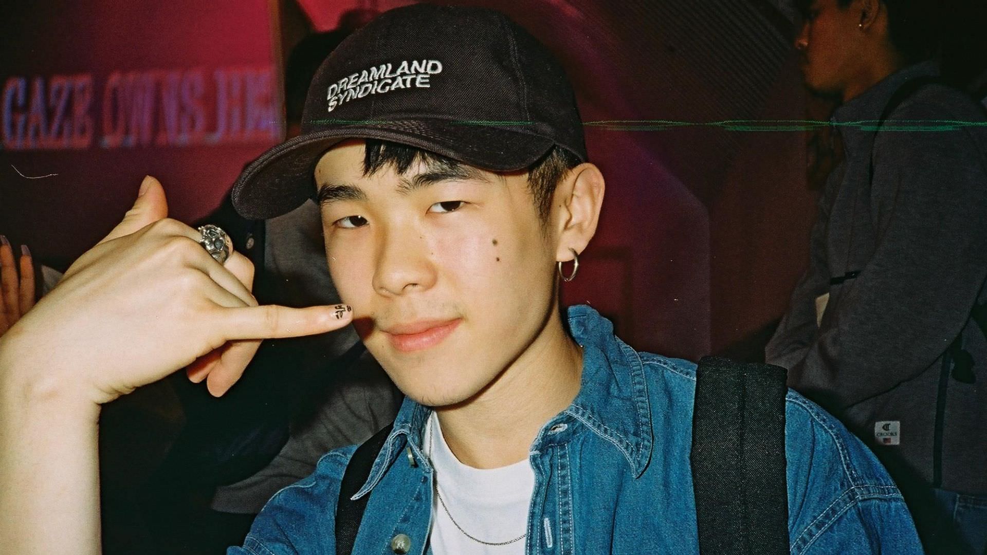 Anthony Lim featured photo in black hat and denim shirt