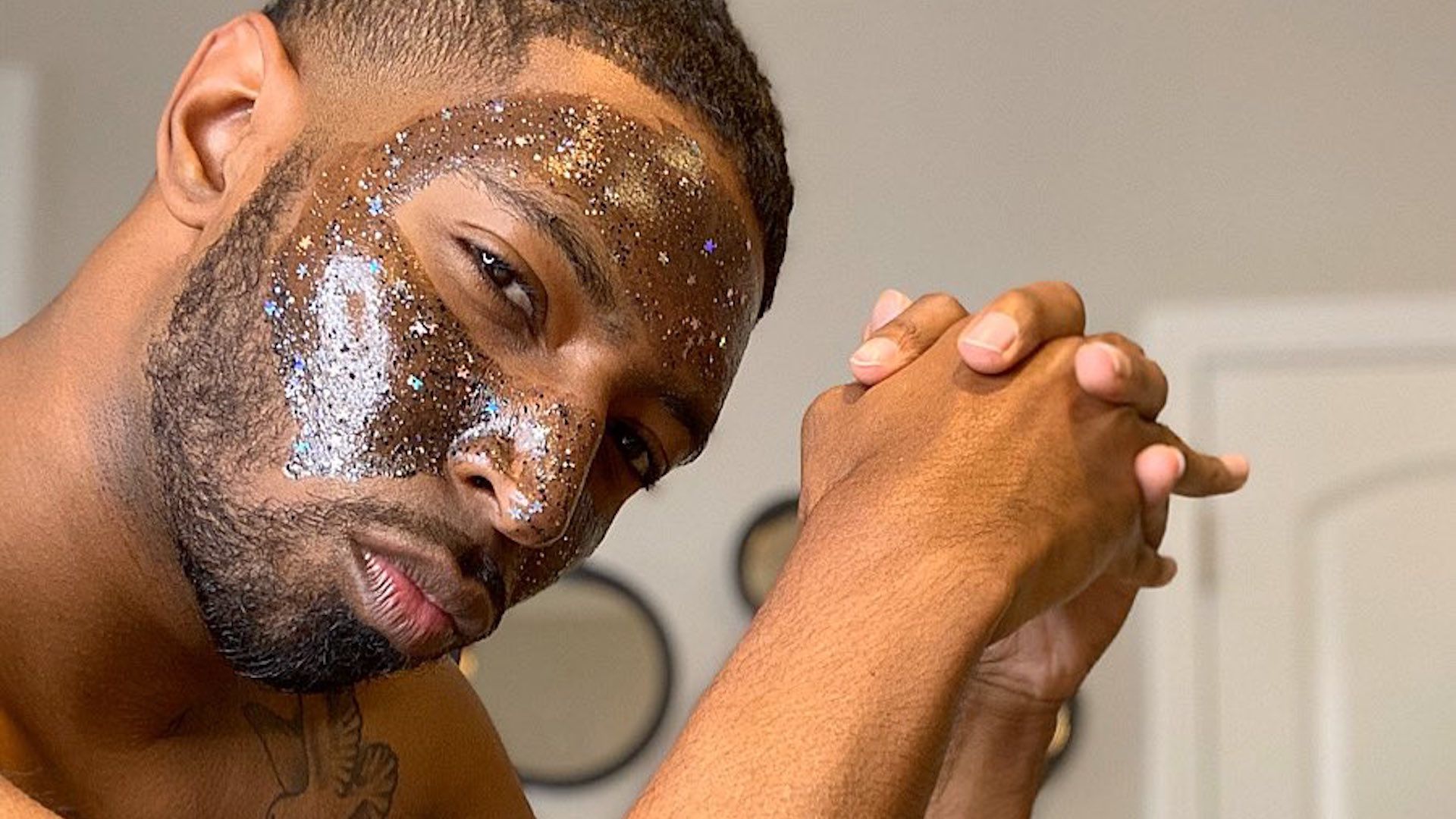 black man wearing glitter face mask skincare