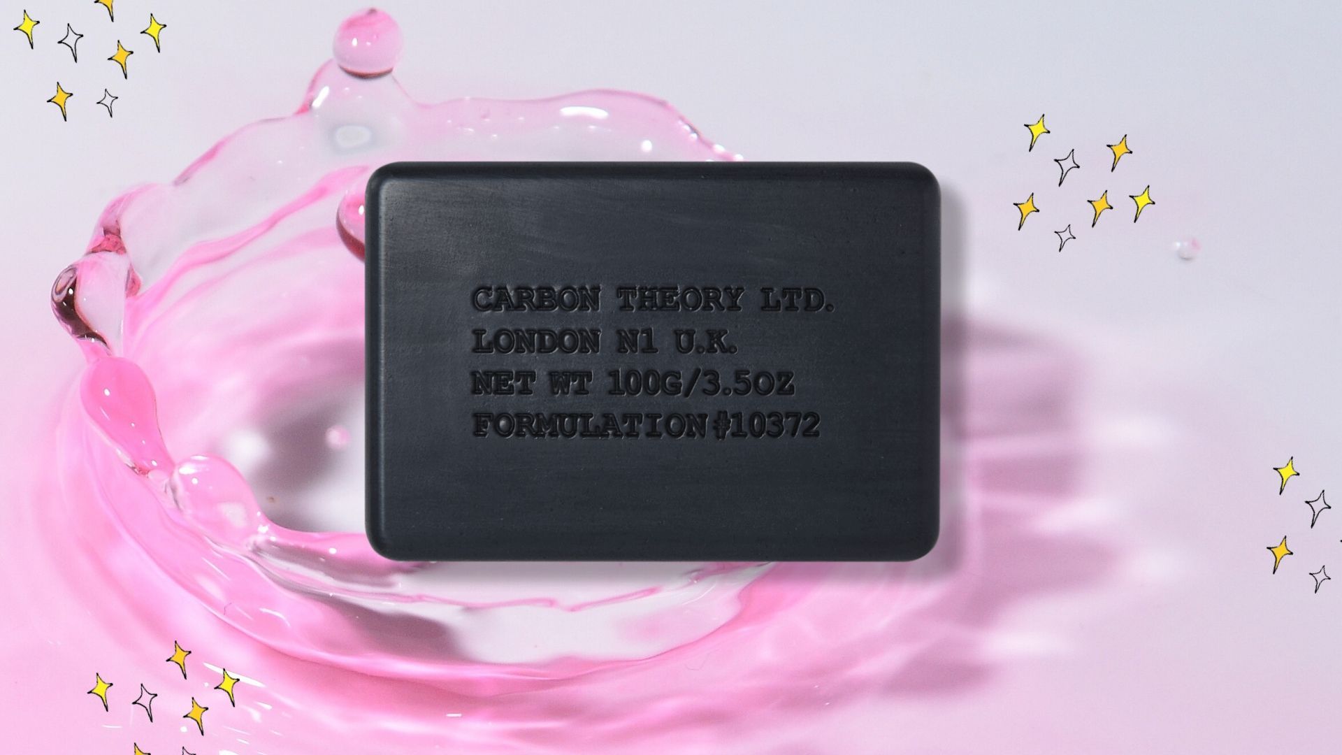 Carbon Theory Bar Soap with pink background and yellow sparkles