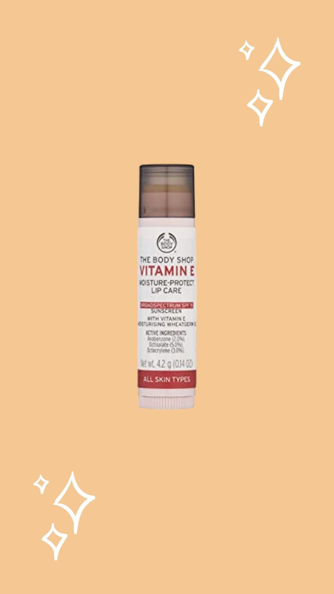 The Body Shop Vitamin E SPF lip balm, orange background with sparkles