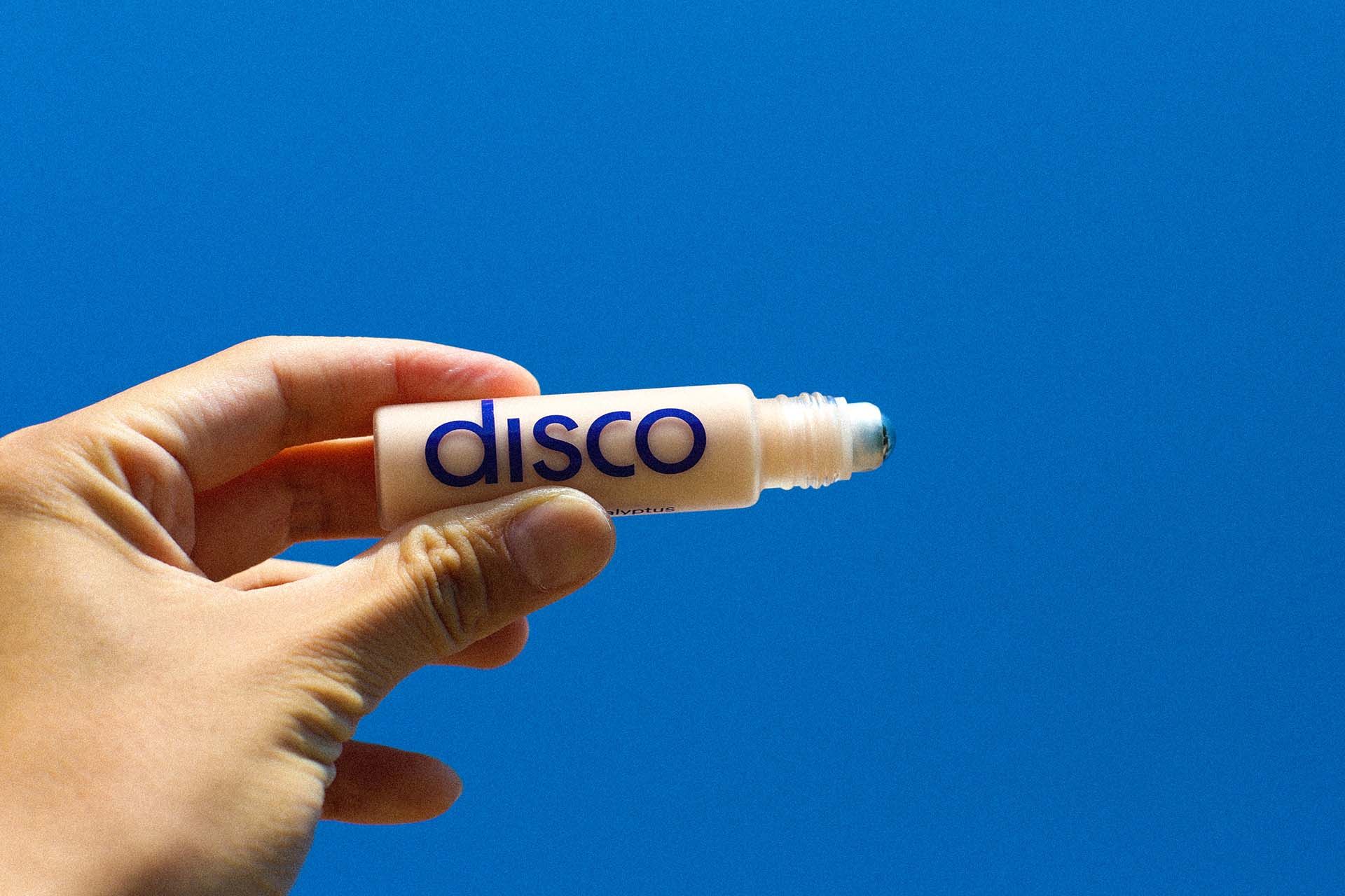 hand holding a disco eye stick against blue background