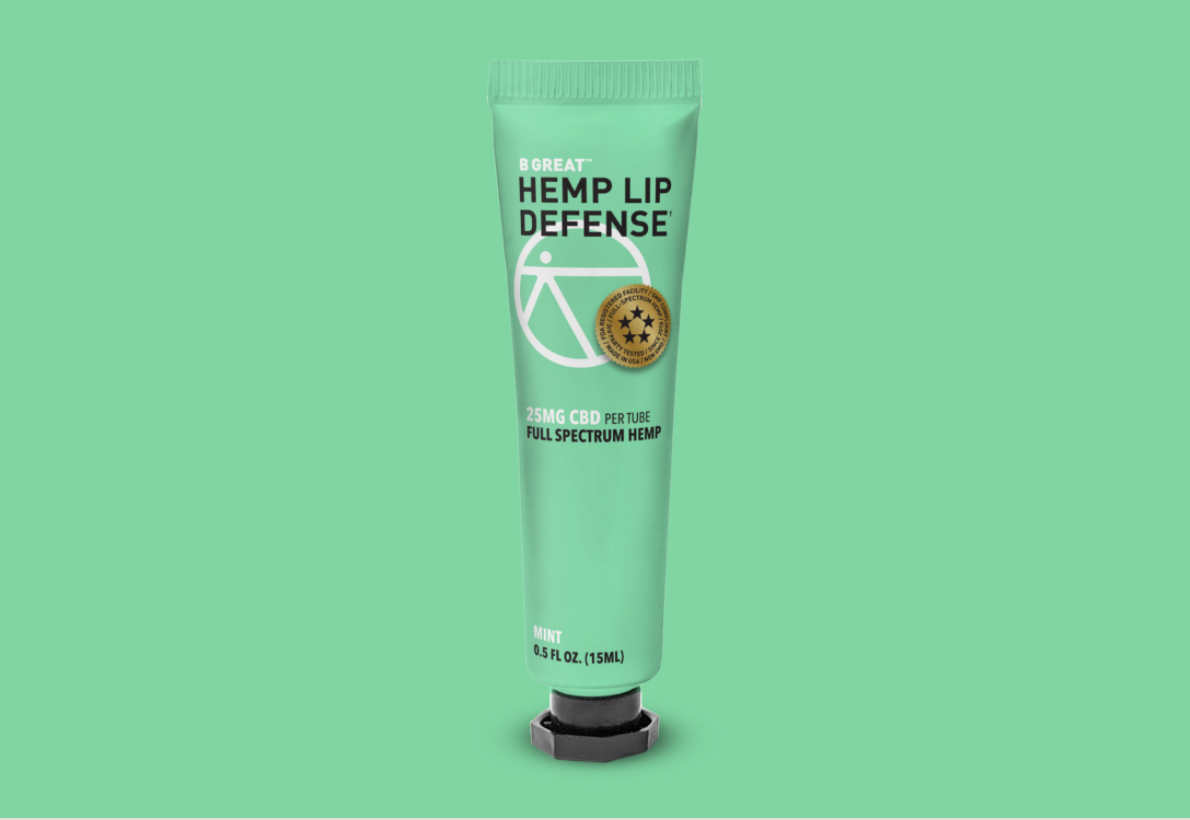 tube of green lip balm on a green background