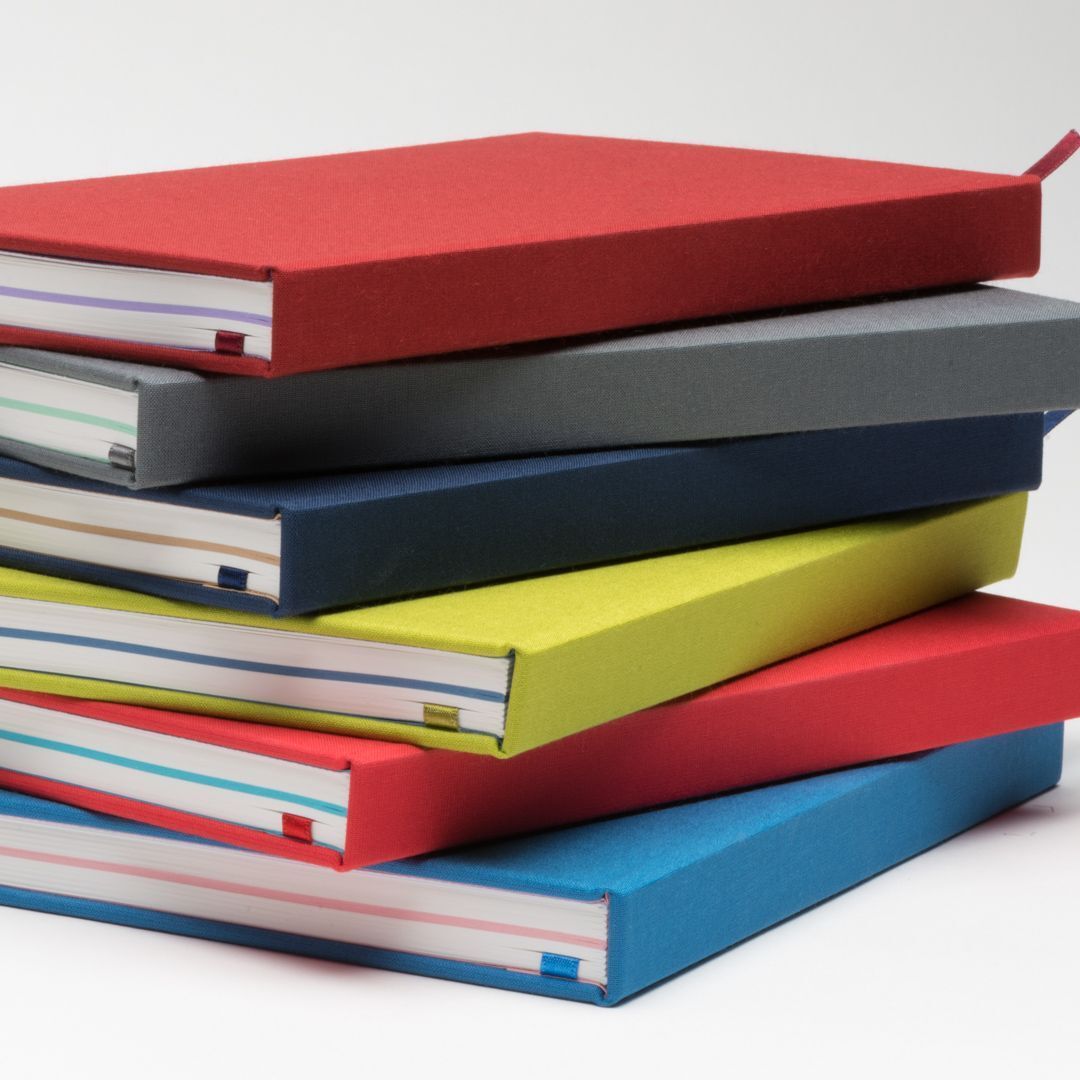 stack of multicolored notebooks