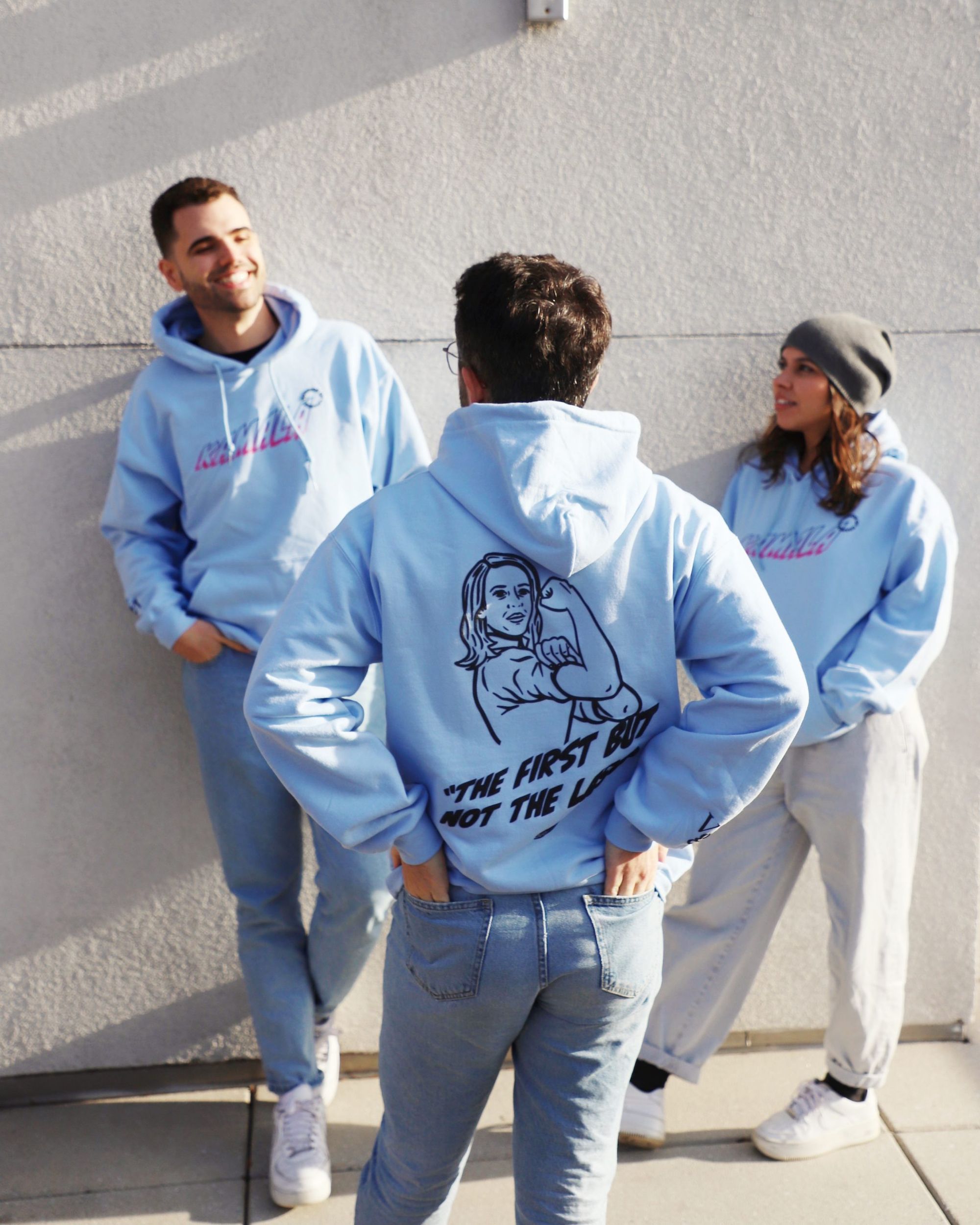 three friends posing wearing the blue VGL kamala hoodie